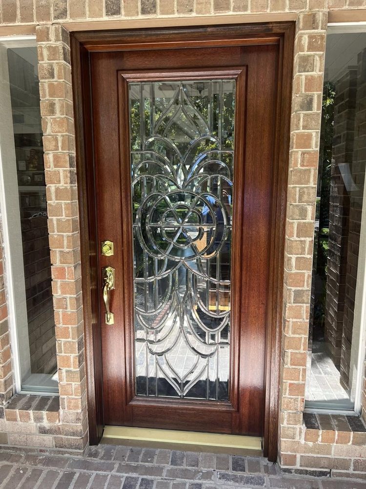 A mahogany entry door with ornate beveled leaded glass, refinished