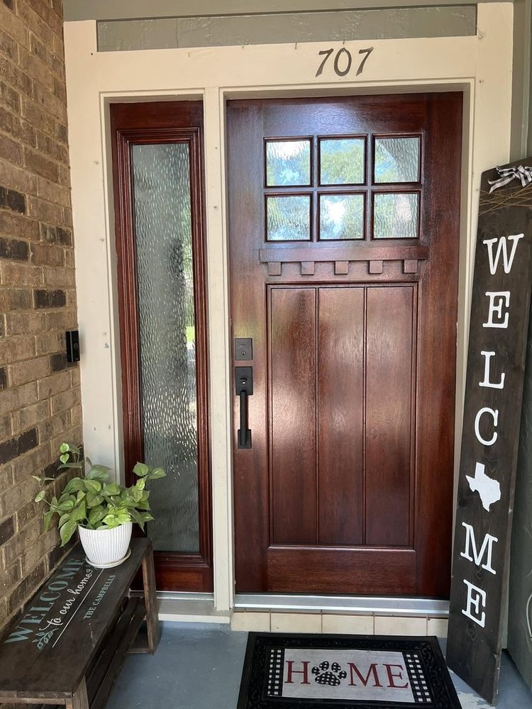 A dark-stained craftsman entry door with a matching sidelight
