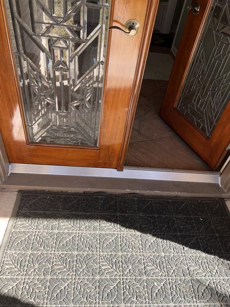 A clean new threshold under refinished doors